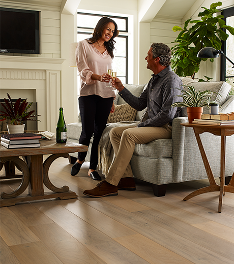 people in living room with hardwood flooring from Flooring Source in the Auburn, MA area