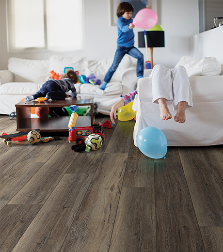 kids playing in room with wood-look laminate flooring from Flooring Source in the Auburn, MA area