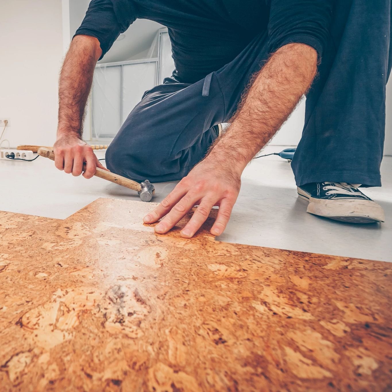 person installing cork flooring from Flooring Source in the Auburn, MA area